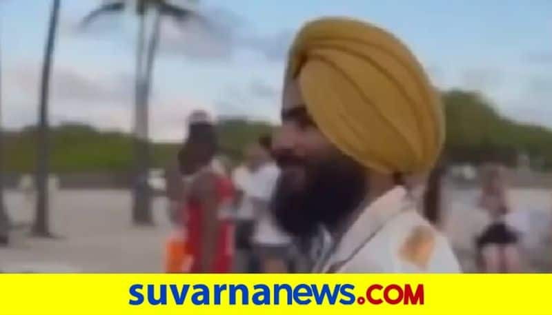 A Sikh man grooving to beats as he joins a group of dancers on the sidewalk in Miami akb