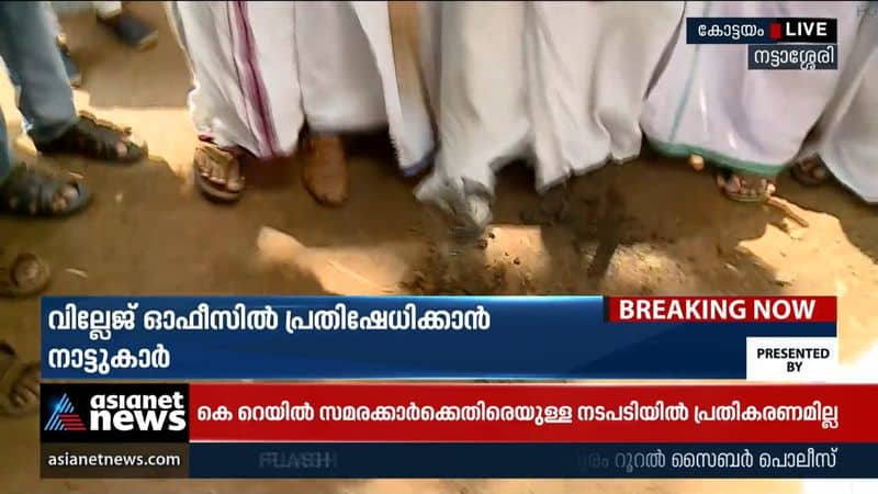 Locals dig and stone in front of the village office