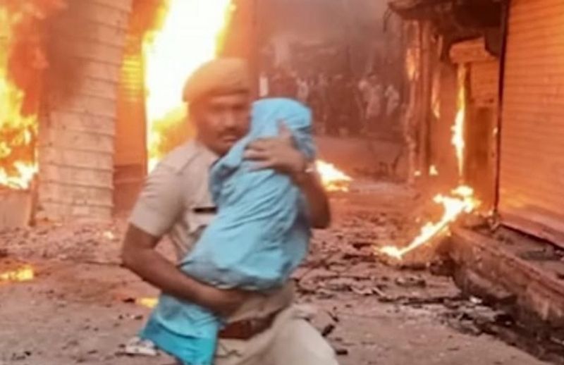 Rajasthan Karauli violence photo of police constable saving an infant being widely praised ckm