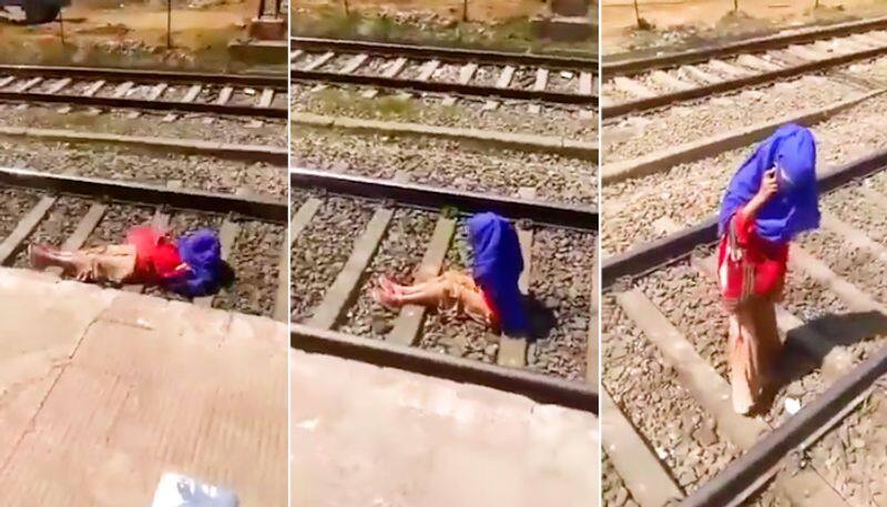 Watch Woman talks on phone as train passes over her; netizens outraged-tgy