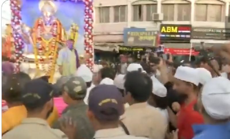 Muslim community shower flower petals on during the Hanuman Jayanti procession