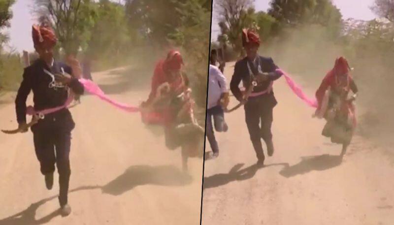 Heres why a newly-wed couple was running on the road in their wedding attire; watch - gps