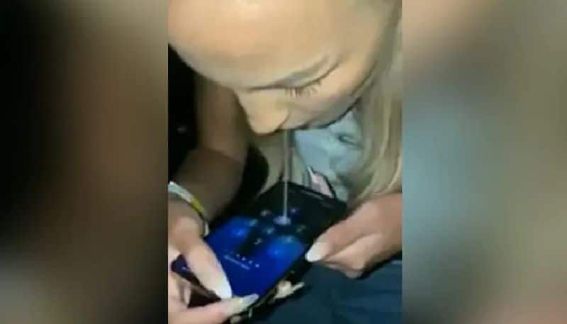 woman uses spits to unlock mobile phone