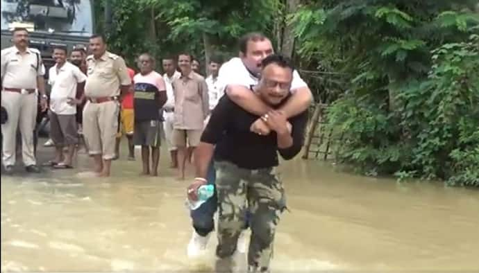 হাঁটুজল পেরোলে নষ্ট হবে দামী জুতো, উদ্ধারকারীর পিঠে চাপলেন বিজেপি বিধায়ক, দেখুন ভাইরাল ভিডিও