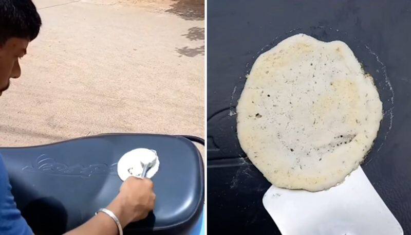 After roti, omelette, scorching heat helps man cook dosa on scooter; Watch-tgy