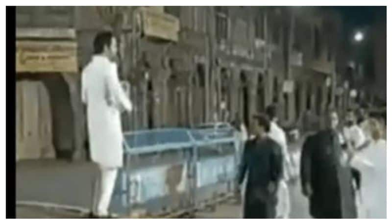 Man throwing currency notes in Charminar 