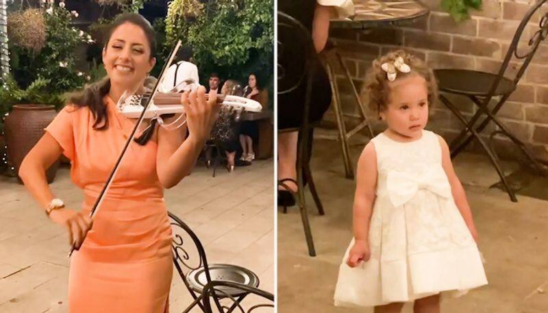 Watch Little Girl's adorable response to woman playing violin is winning hearts-tgy