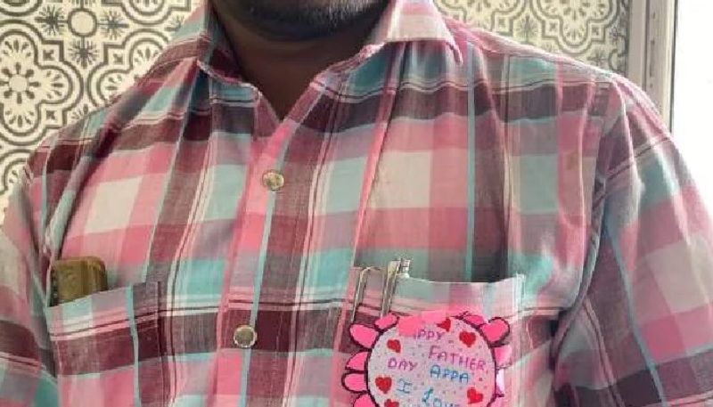 daughter gifts a beautiful badge wishing him fathers day and he wears it whole day 