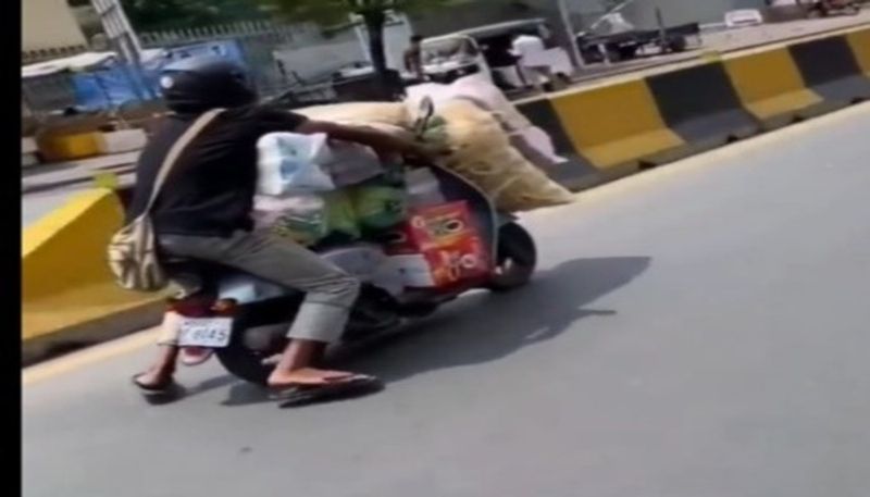 Man rides overloaded scooter in viral video. Telangana State Police reacts