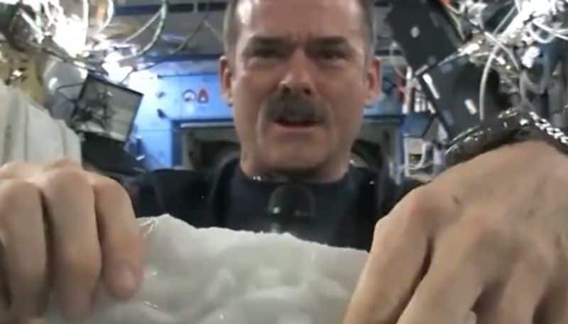 squeezing wet towel in space watch video 