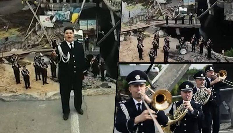 An ode to courage national police day Ukrainian cops sing national anthem over bridge Russians bombed snt