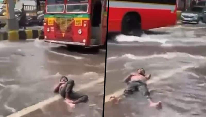 Man lies on waterlogged Mumbai road: Social media compares 'Malad' with Maldives - gps