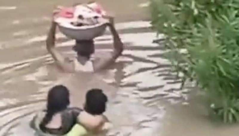 man carried baby in basket in flood