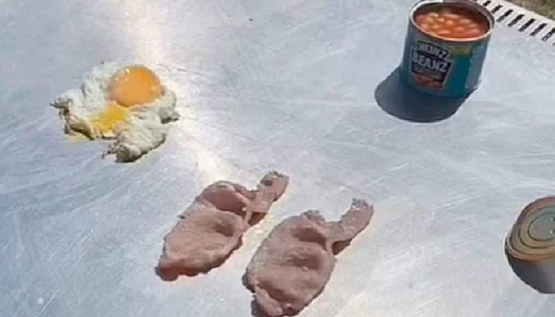 man cooks breakfast in suns heat amid heat wave