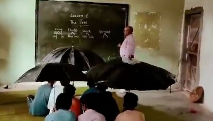 Watch: MP students sit with umbrellas inside classroom due to leaking roof 