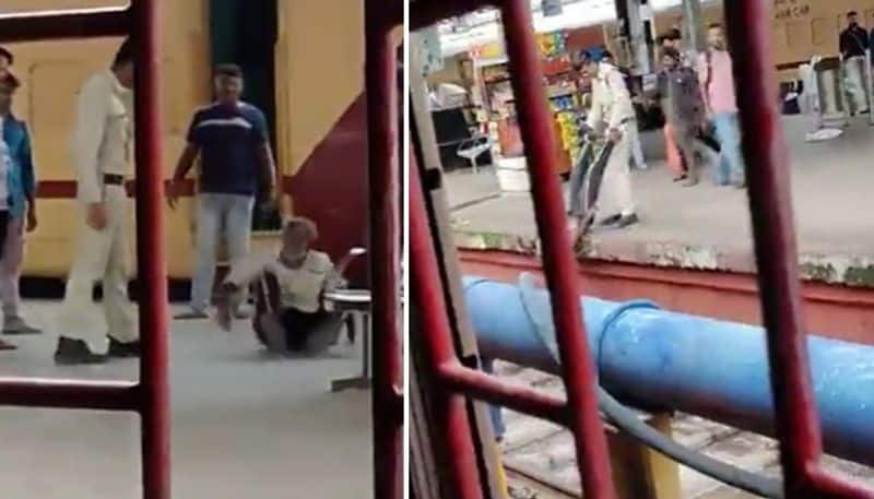 cop kicks and dangles an elderly man at railway station 