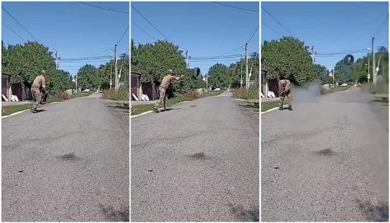 Ukraine soldier demolishing a bomb with a tyre