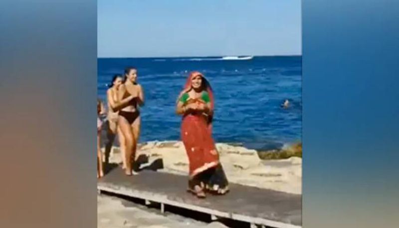 Woman wear saree in a foreign beach 