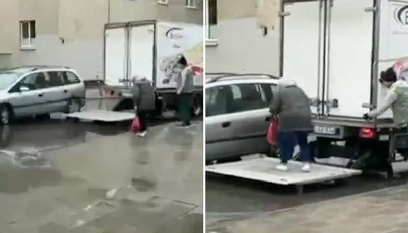 Watch Truck driver helping elderly woman cross waterlogged street wins internet hearts-tgy