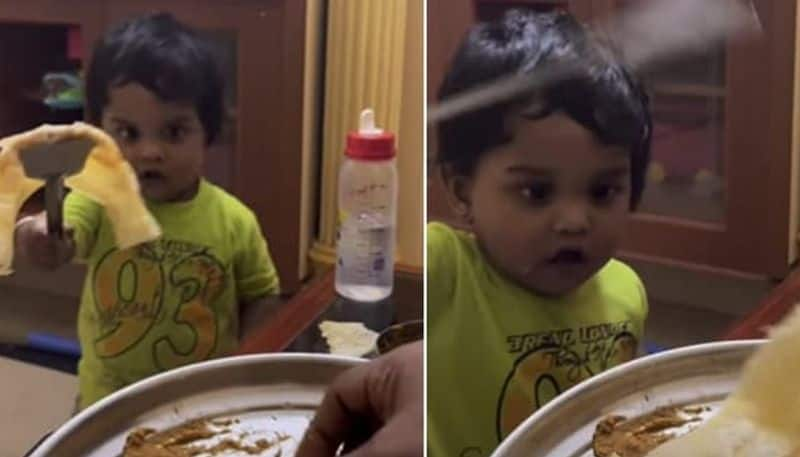 toddler serves dosa for his mother 