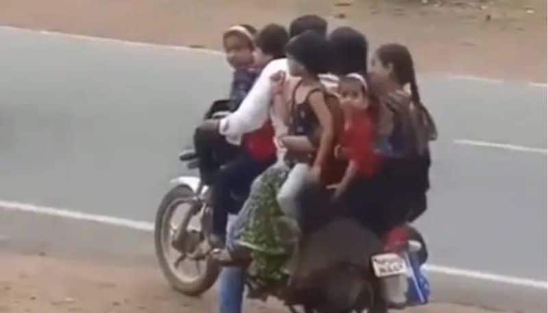 seven members of a family on a single motor cycle 