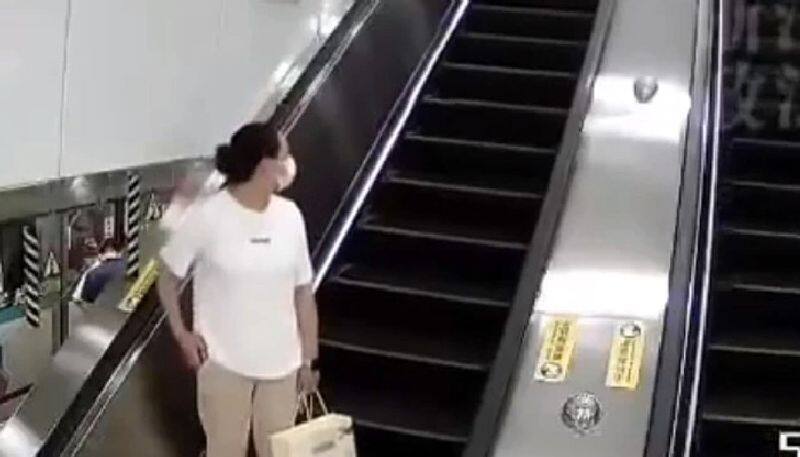 woman uses escalator as luggage conveyor belt and that made an accident 