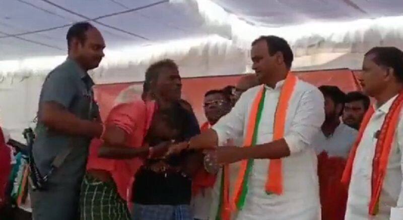 drunk man kisses bjp leader hand and created nuisance on the stage in telangana