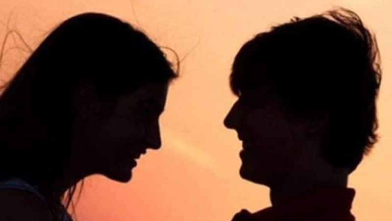 young woman drinking alcohol with young men at Marina Beach in Chennai tvk