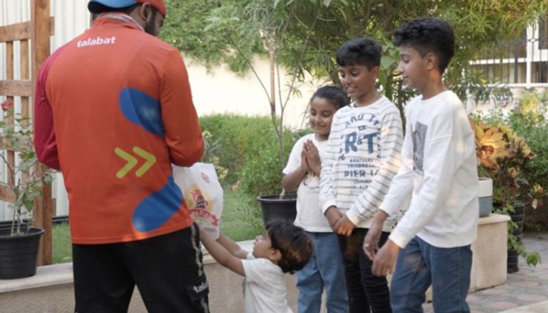 children gift food to delivery boys on mothers birthday