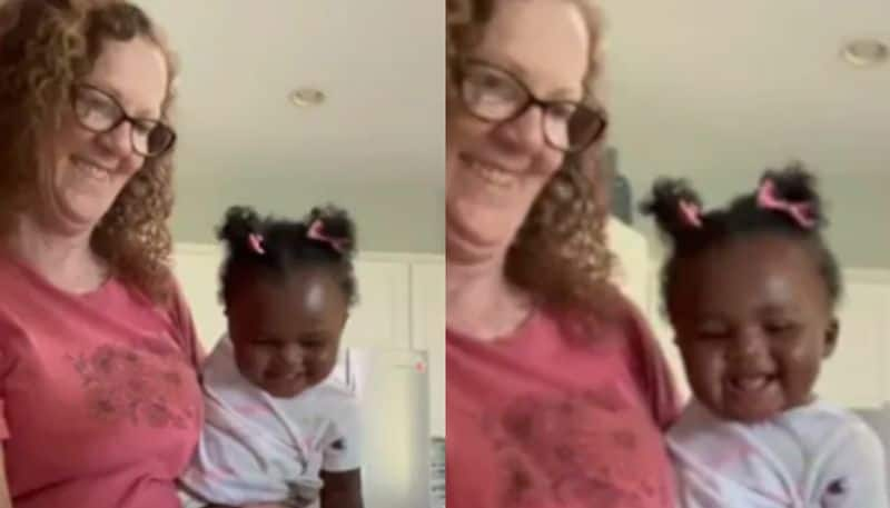 Baby Bursts Out Laughing As Grandma Cuts Vegetables