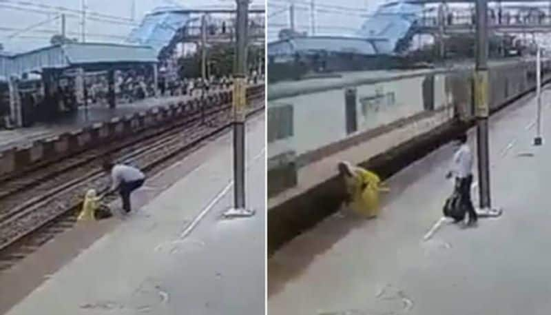 Woman crossing railway track when train enter to the station 