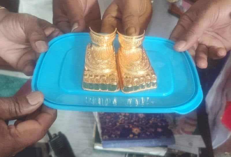 A devotee offering golden feet to the Padmavathi temple in Tiruchanur