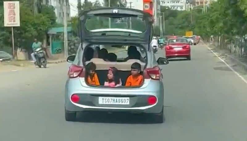 Watch Video of kids sitting in the open boot of a moving car goes viral; Netizens loads with criticism-tgy