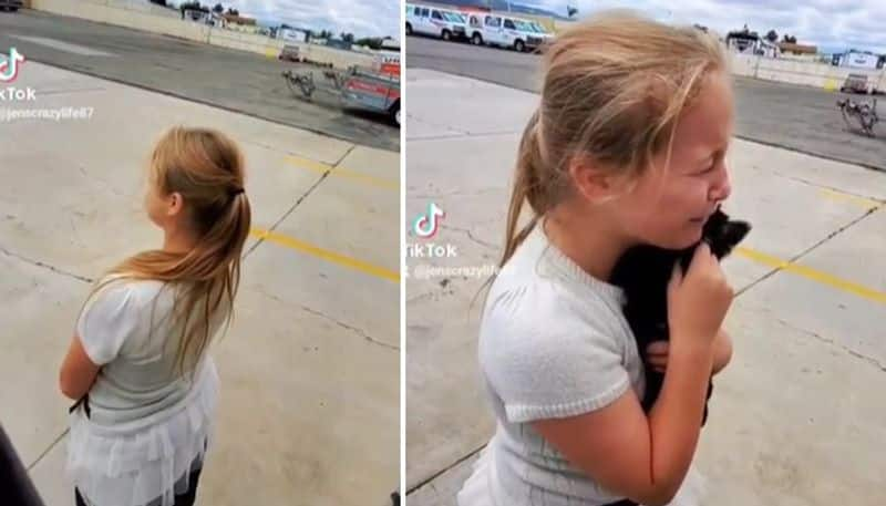 girl crying when she got a puppy as birthday gift 