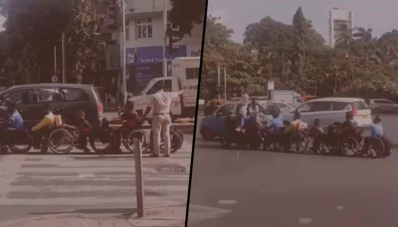 Mumbai traffic cop helps specially-abled people cross busy road; netizens lauds his gesture - gps