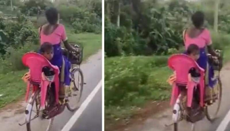 Mother makes variety backseat for child on bicycle