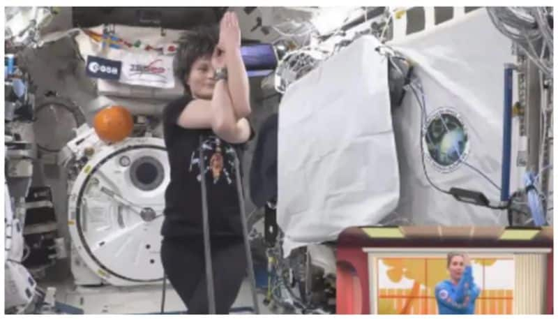 young woman doing yoga in space