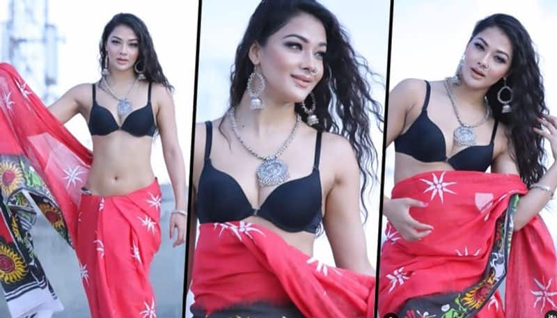 Sexy Bhojpuri video pics Namrata Malla twirls in bikini blouse red hot saree drb