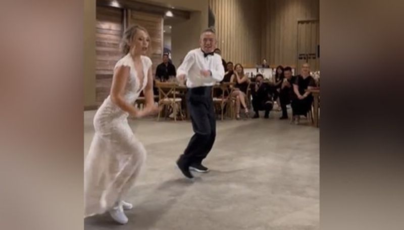 bride and her father dancing together on wedding day