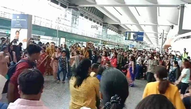 employees and passengers perform  Garba  at airport 