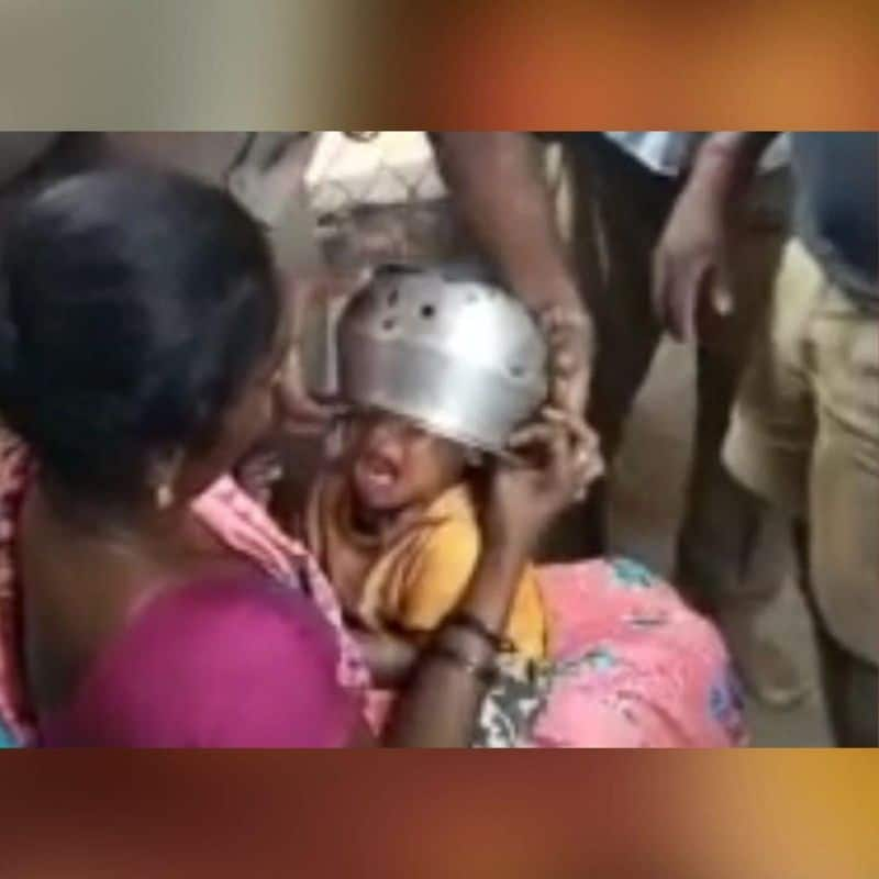 a child head stuck in a bowl