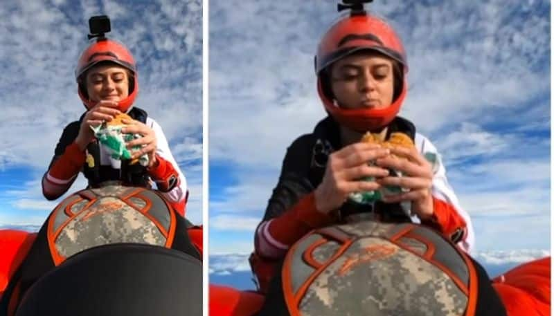 Woman eats burger while skydiving in viral video