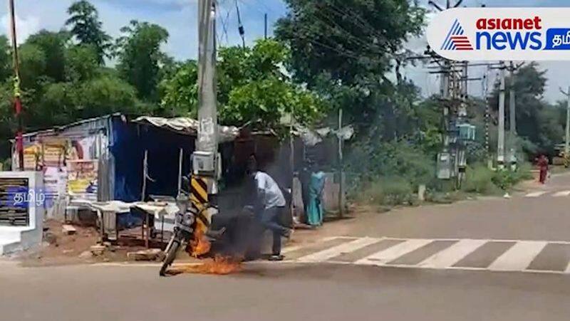 A two-wheeler caught fire in the middle of the road near sivagangai