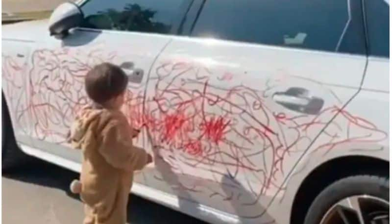 Boy Scribbles On A Car With Lipstick