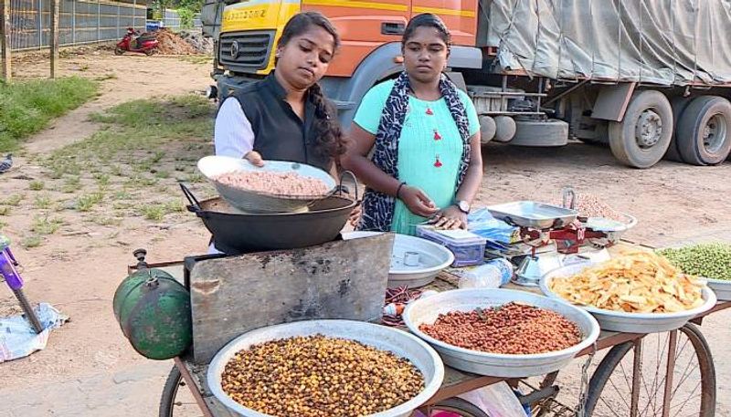 Student selling pea nuts near her school 