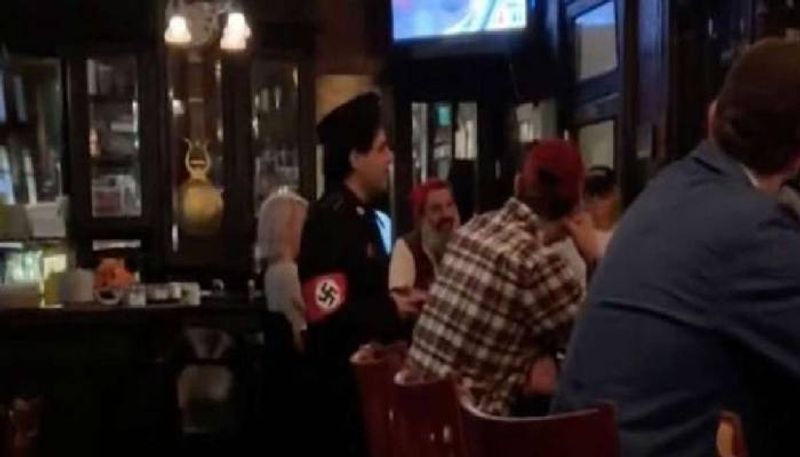 man enter bar in nazi costume forced out by people 