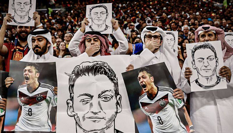 FIFA World Cup 2022 Fans in Qatar held up photos of Mesut Ozil and covered their mouths during Germany vs Spain match