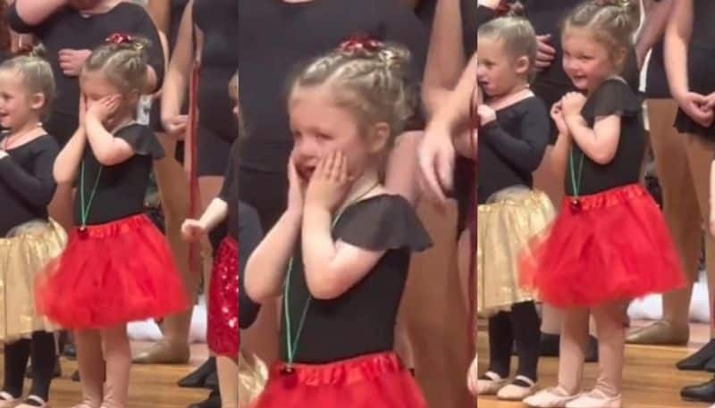 Little girl spots her family in the crowd ahead of her stage performance