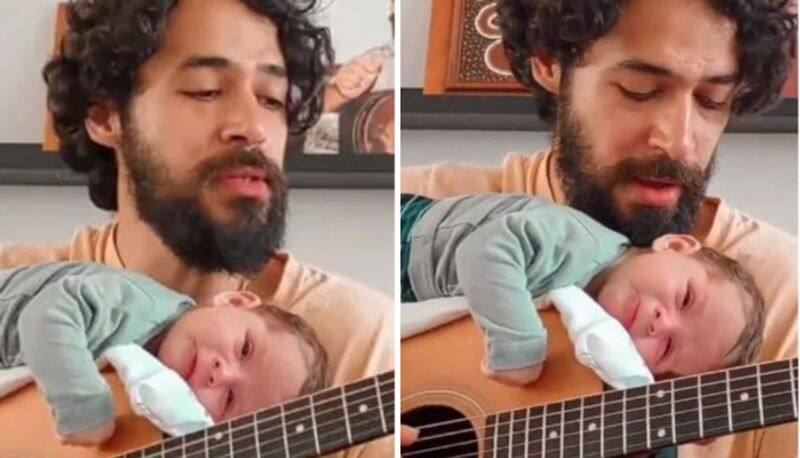 father sings lullaby to his baby little childs reaction melts hearts online