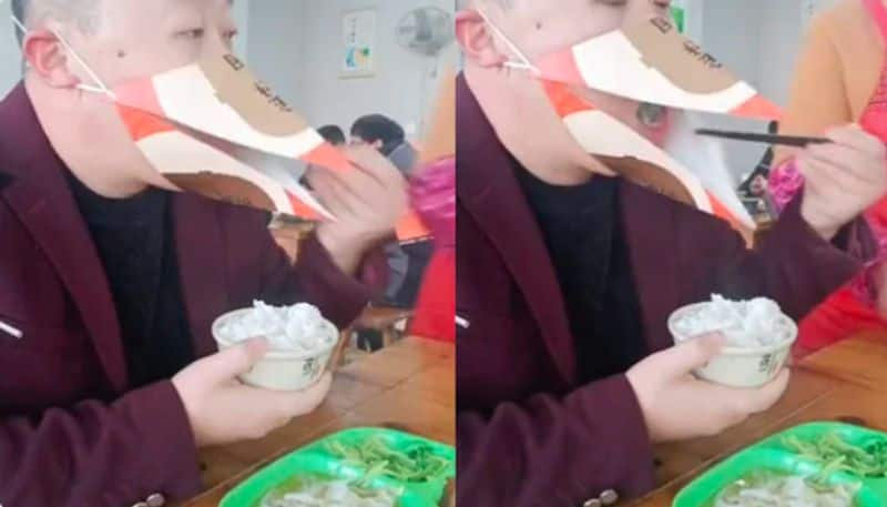 Man Uses Beak Shaped Mask To Eat Rice At Restaurant